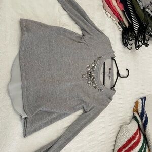 Grey Jennifer Lopez sweater with rhinestone neckline #glamour